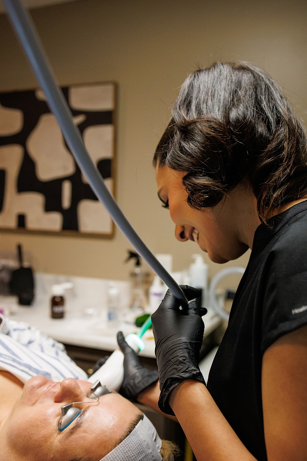 Smiling woman touching her neck and shoulder.
